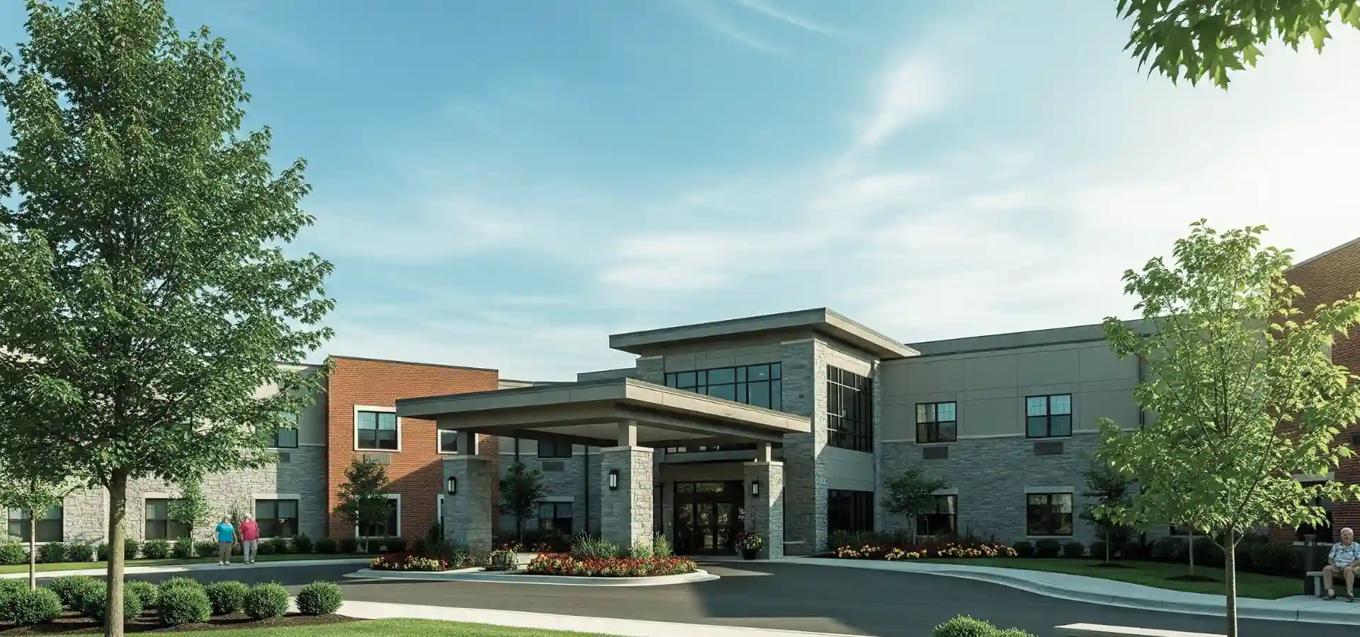 Entrance of a modern senior living community with stone and brick exterior and landscaped grounds.